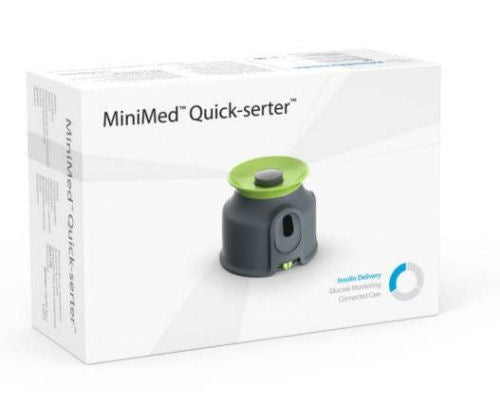 MiniMed Quick-Serter. Device is black and green plastic, packaged in a small white cardboard box.
